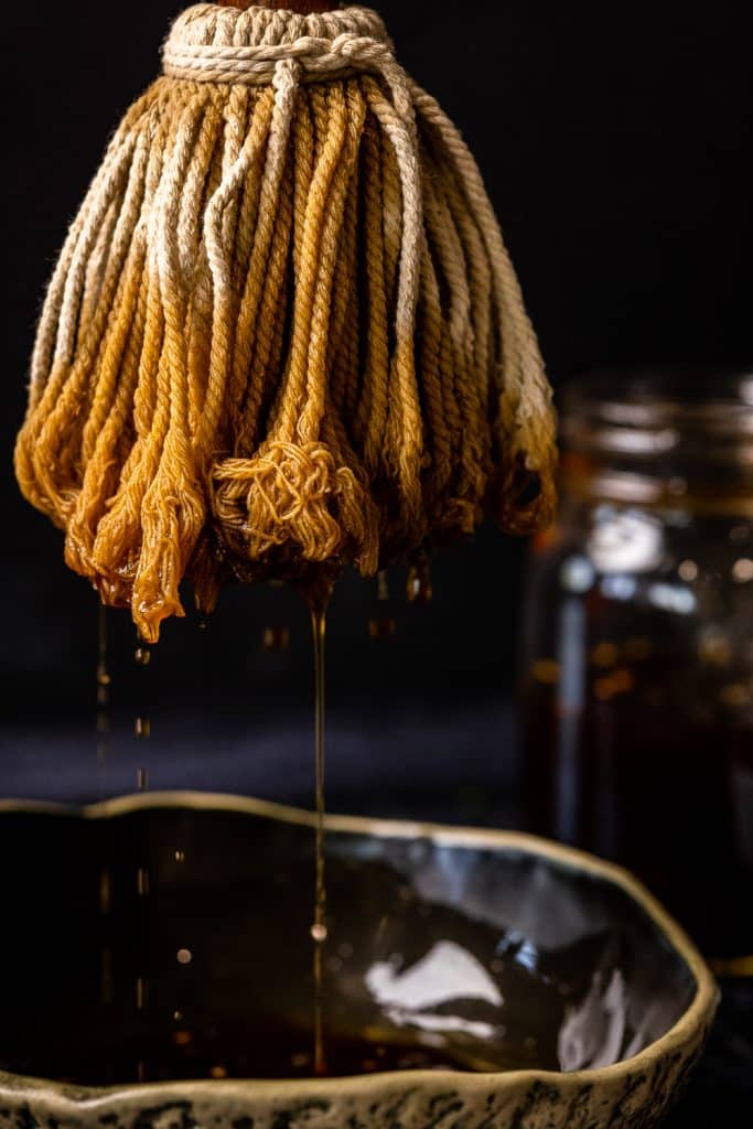 BBQ mop dripping with BBQ mop sauce.