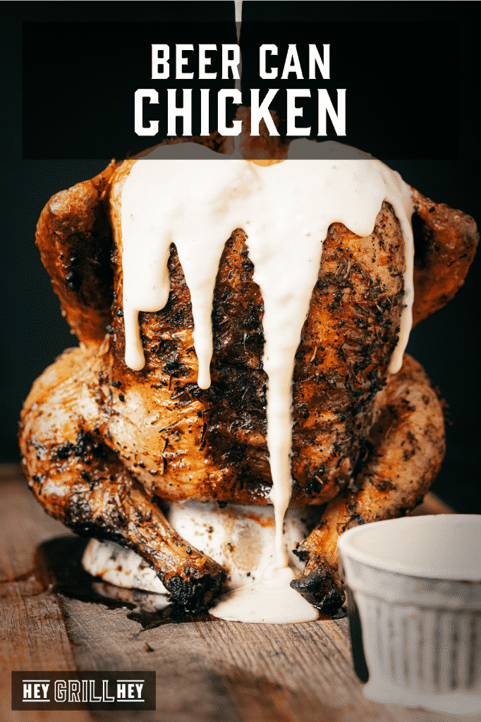 Beer can chicken covered in beer cheese with text overlay - Beer Can Chicken.