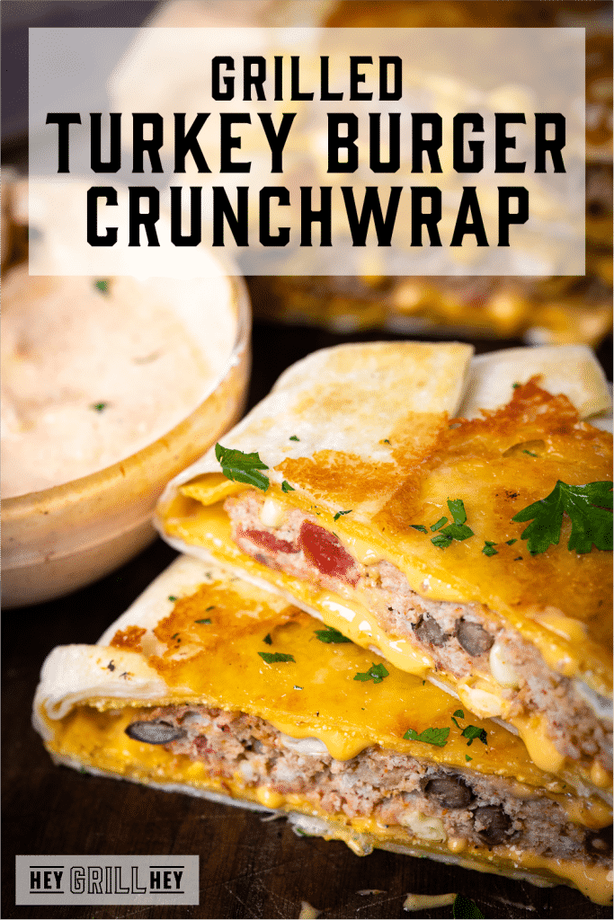 Two halves of a grilled turkey burger crunchwrap next to chipotle sour cream dipping sauce with text overlay - Grilled Turkey Burger Crunchwrap.