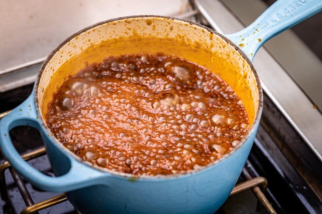 Hawaiian BBQ sauce in a large pot at a boil.