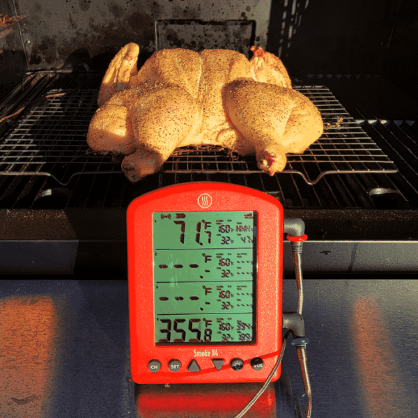 ThermoWorks Smoke X4 in front of a spatchcocked chicken.