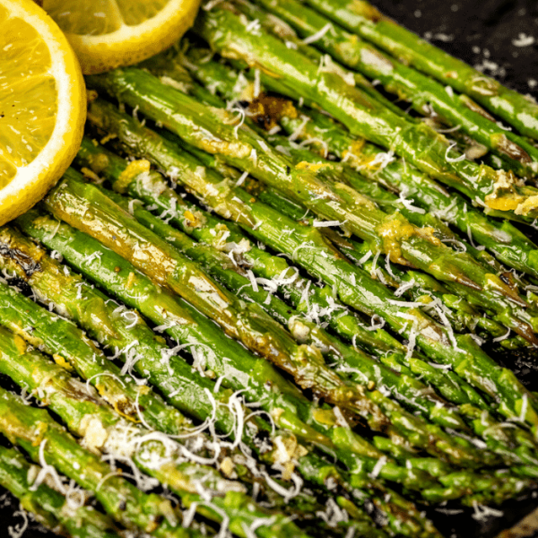 Stacked grilled asparagus topped with shredded parmesan cheese.