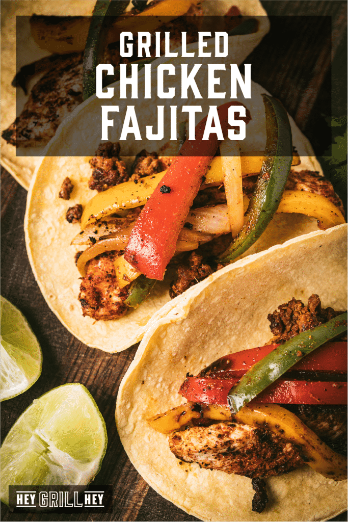 Three grilled chicken fajitas on a wooden serving board with text overlay - Grilled Chicken Fajitas.