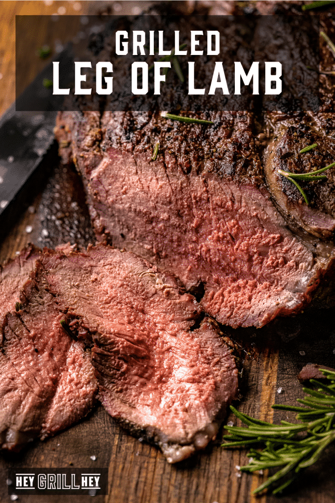 Sliced leg of lamb on a wooden cutting board with text overlay - Grilled Leg of Lamb.