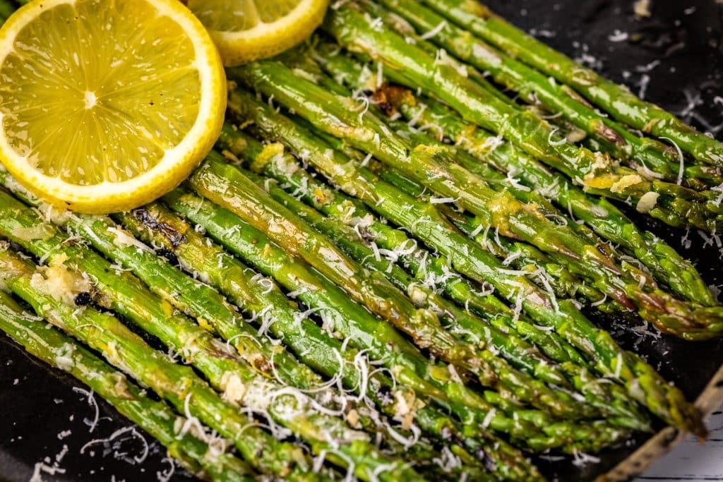 Stacked grilled asparagus topped with shredded parmesan cheese.