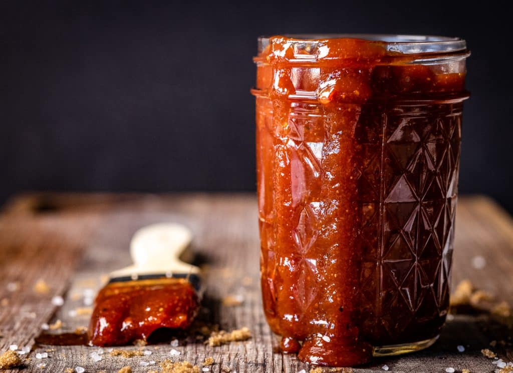 Honey chipotle BBQ sauce in a glass mason jar.