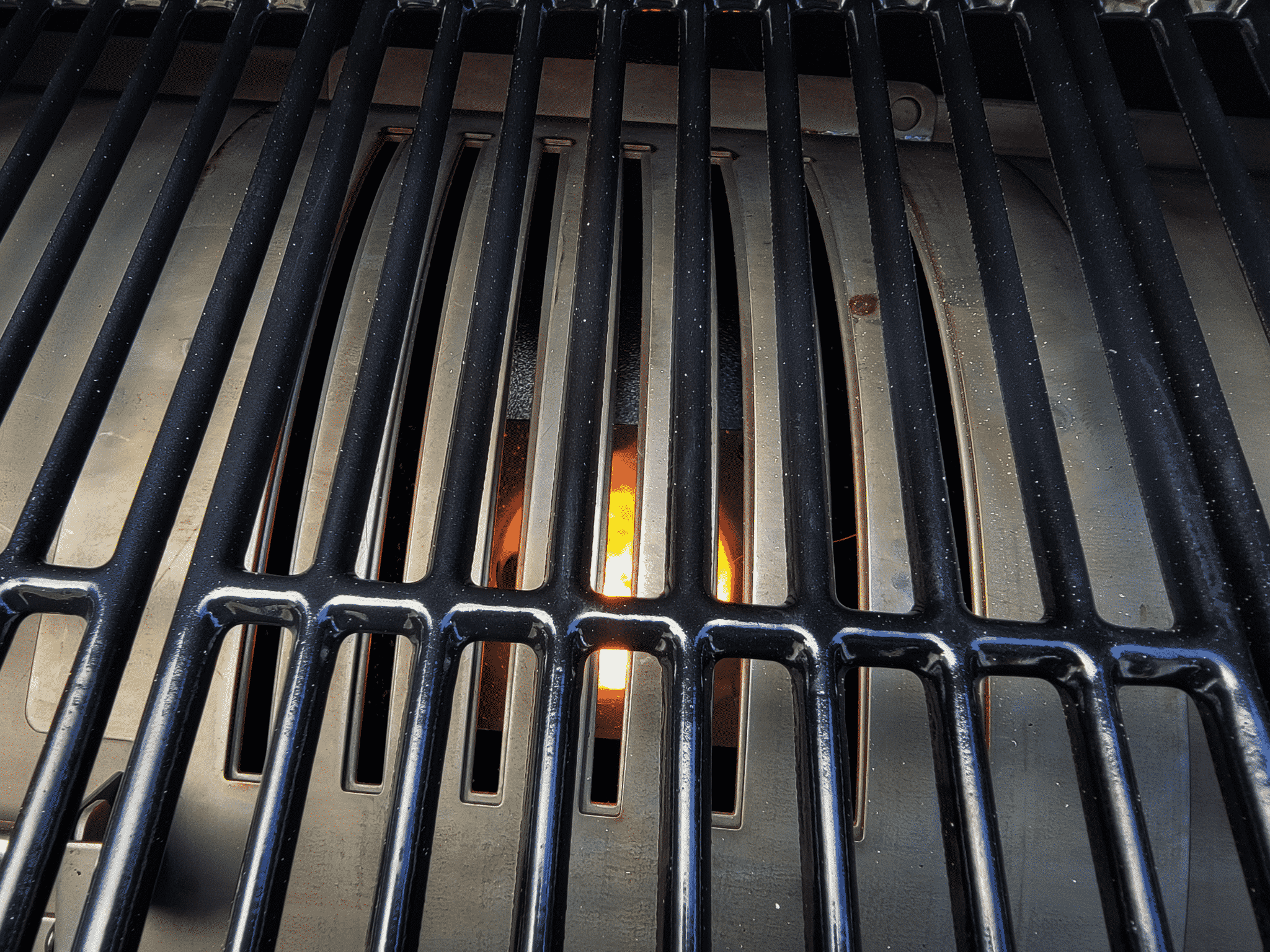 fire burning below grill grates
