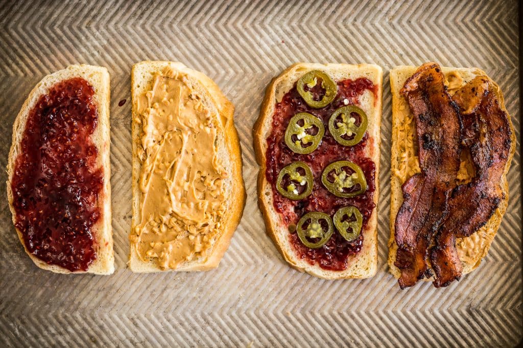 Peanut butter, jelly, bacon, and candied jalapenos layered on 4 slices of sourdough bread.