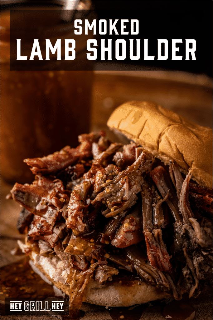 Shredded smoked pulled pork between buns with text overlay - Smoked Lamb Shoulder.
