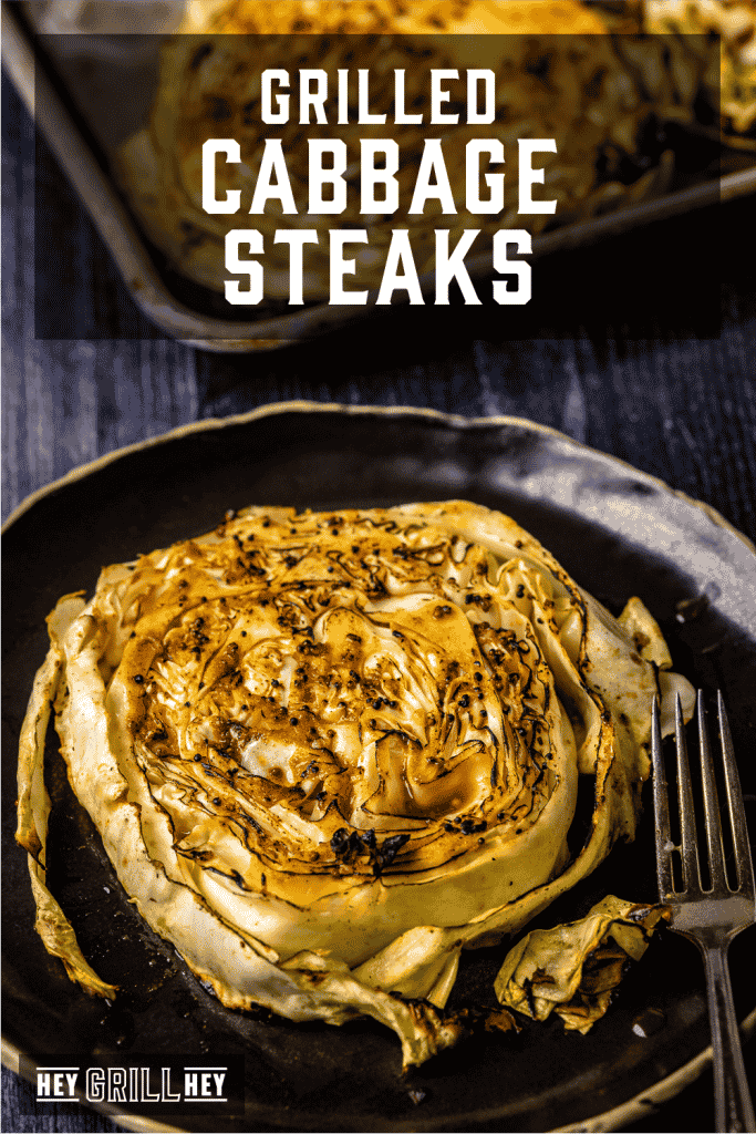 Grilled cabbage steak on a serving dish with text overlay - Grilled Cabbage Steaks.