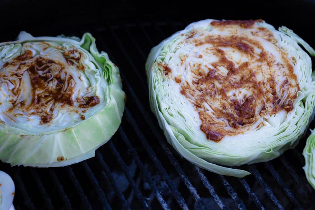 Seasoned cabbage steaks on the grill.