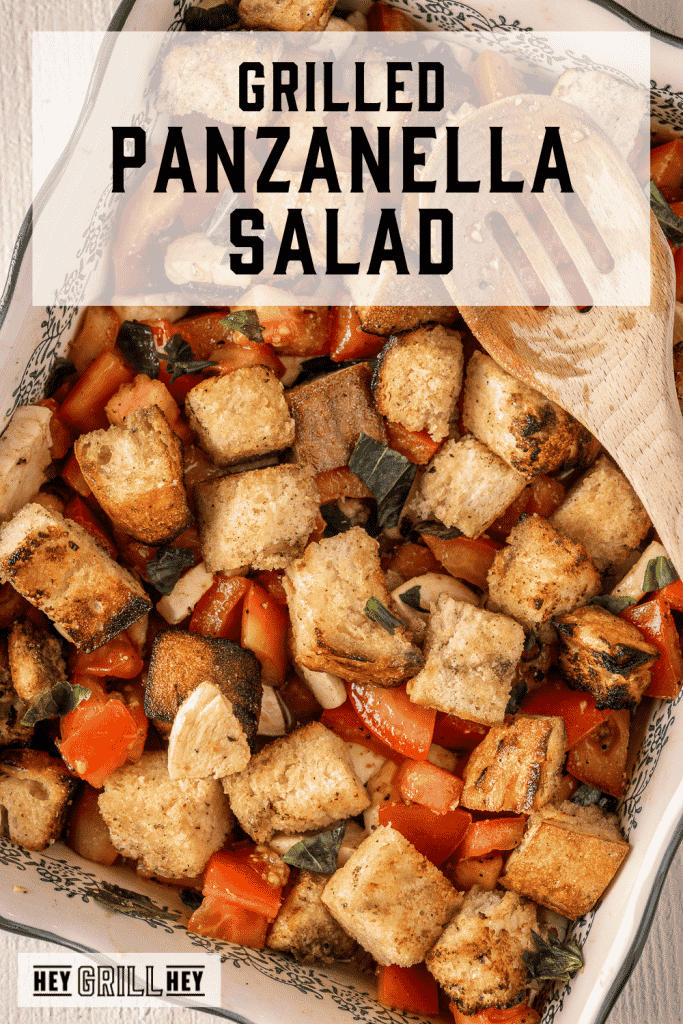 Grilled panzanella salad in a white serving dish with text overlay - Grilled Panzanella Salad.