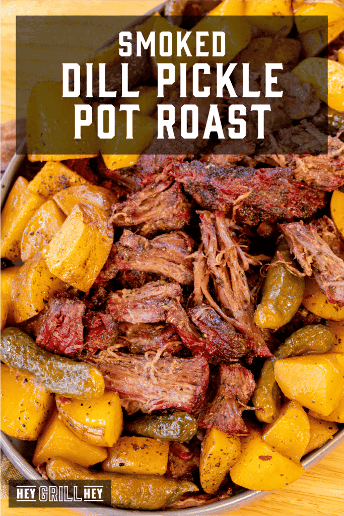 Smoked dill pickle pot roast surrounded by pickles and potatoes with text overlay - Smoked Dill Pickle Pot Roast.