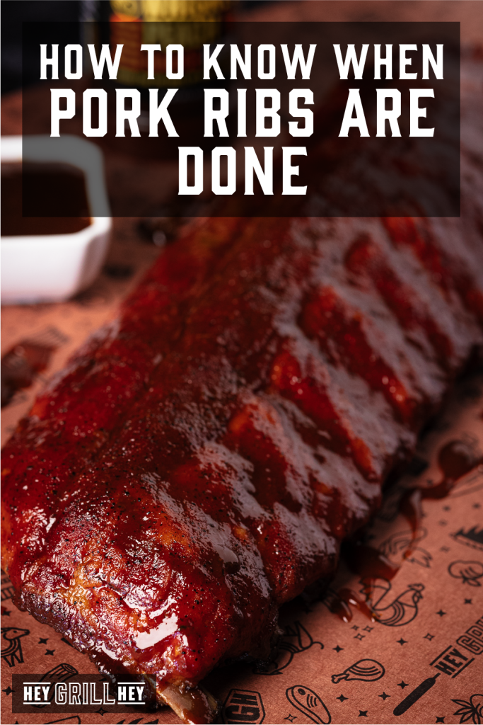 Pork ribs resting on peach butcher paper with text overlay - How to Know When Pork Ribs are Done.