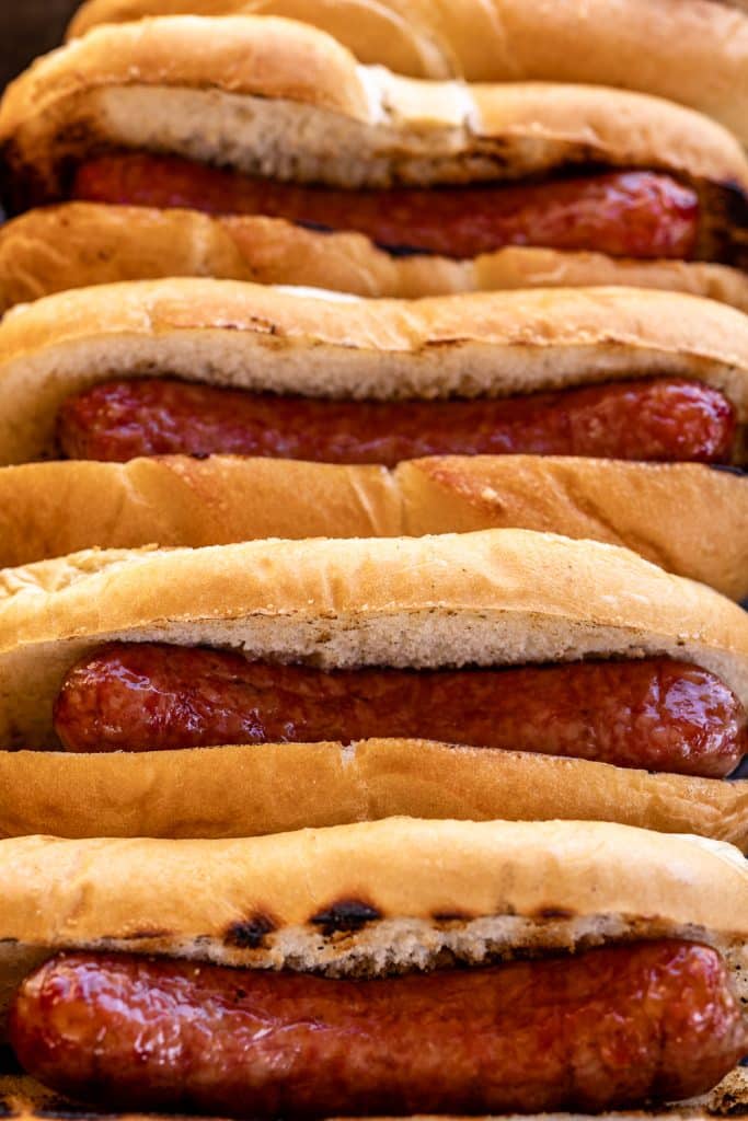 Smoked brats in hot dog buns.