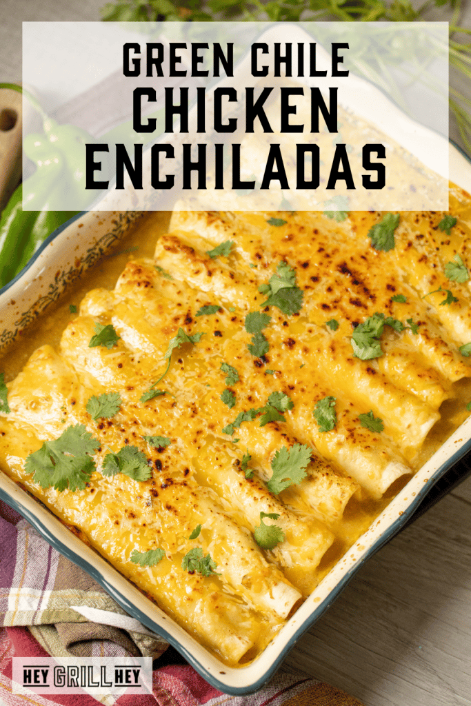 Smoked green chile chicken enchiladas in a large serving dish with text overlay - Green Chile Chicken Enchiladas.