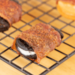 Bacon wrapped oreo on a cooking rack.
