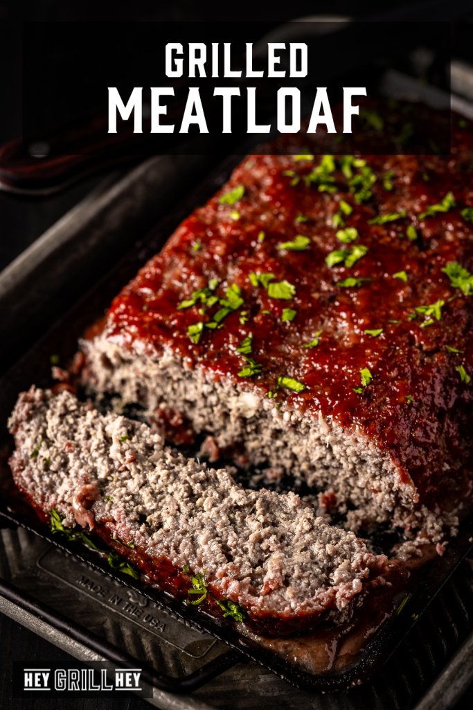 Sliced grilled meatloaf in a baking dish with text overlay - Grilled Meatloaf.