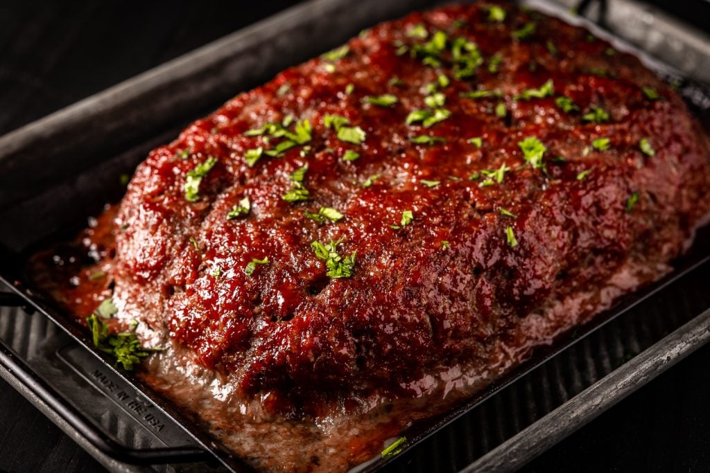 Grilled meatloaf in a baking dish.