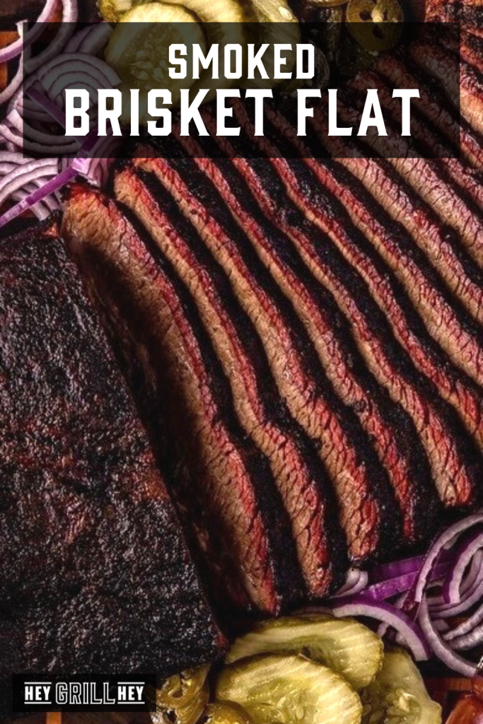 Sliced brisket flat on a serving platter with text overlay - Smoked Brisket Flat.