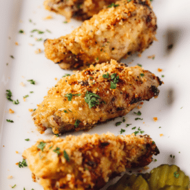 Dill pickle chicken wings lined up on a serving dish.