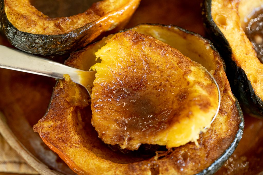 Scoop of smoked acorn squash on a large spoon.