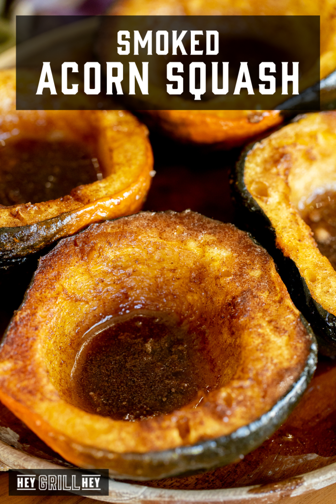 Smoked acorn halves on a serving dish with text overlay - Smoked Acorn Squash.