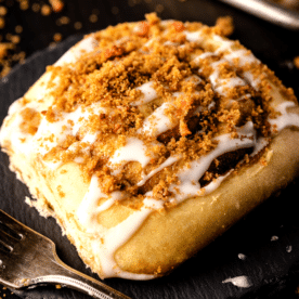 Smoked cinnamon roll on a serving plate.