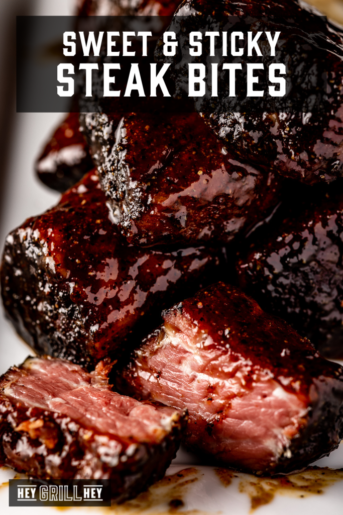Steak bites piled on a white serving platter with text overlay - Sweet and Sticky Steak Bites.