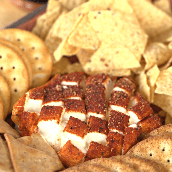 Smoked cream cheese surrounded by chips and crackers.
