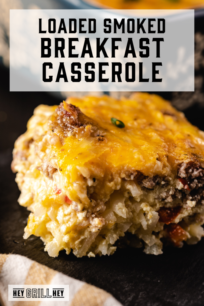 Slice of breakfast casserole on a plate with a text overlay that says Loaded Smoked Breakfast Casserole