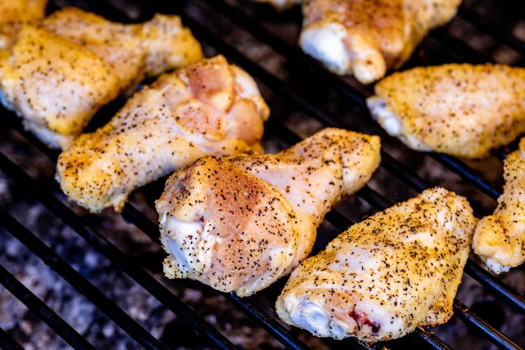 Seasoned chicken wings on the grill.