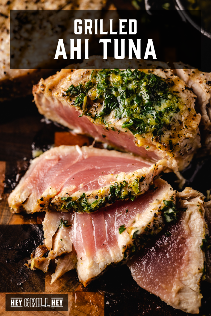 Sliced grilled ahi tuna steaks on a wooden cutting board with text overlay - Grilled Ahi Tuna.