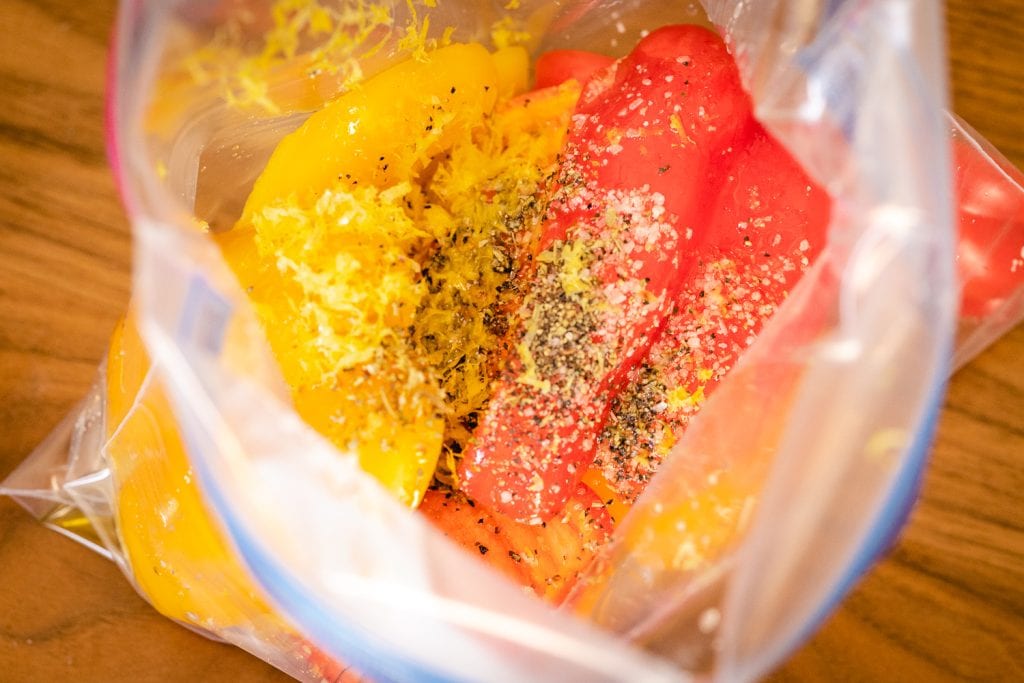 Seasonings and bell peppers in a gallon-sized zip-top bag.