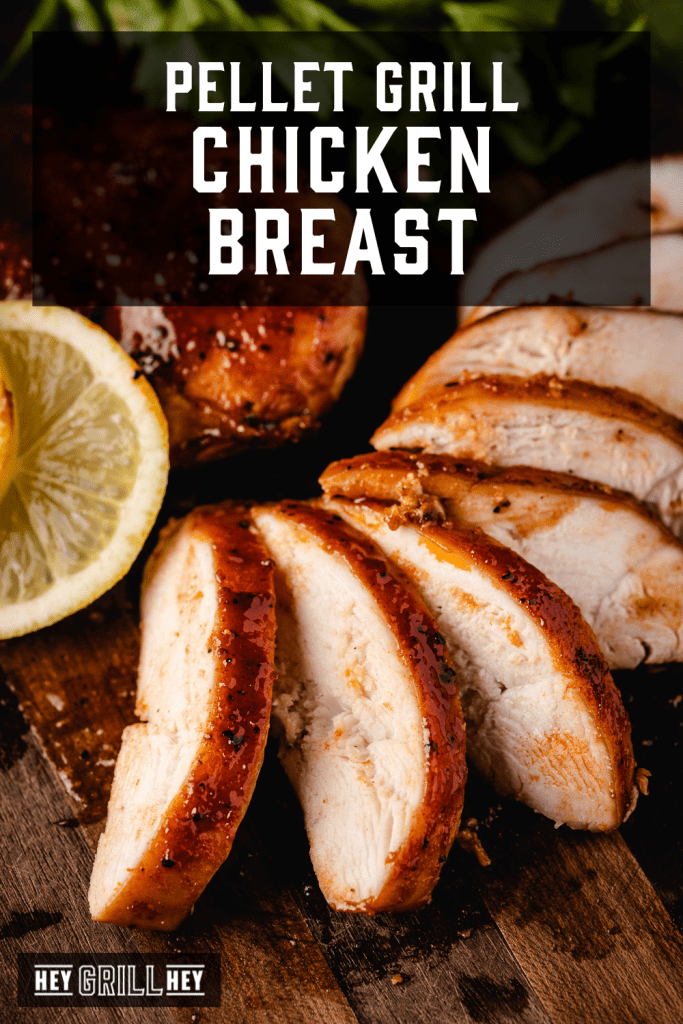 Chicken breast sliced and spread out on a wooden cutting board with text overlay - Pellet Grill Chicken Breast.