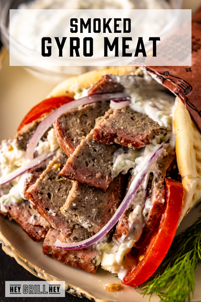 Gyro with smoked gyro meat on a serving platter with text overlay - Smoked Gyro Meat.