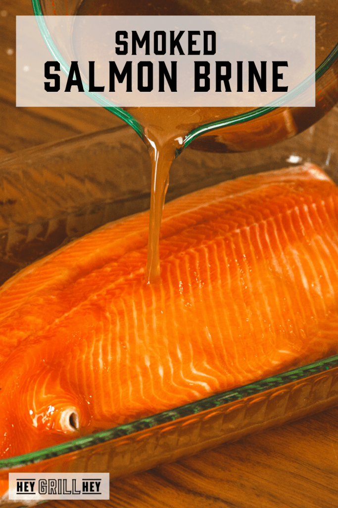 Salmon brine being poured over a large salmon filet with text overlay - Smoked Salmon Brine.