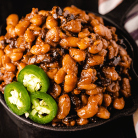 BBQ baked beans in a cast iron skillet.