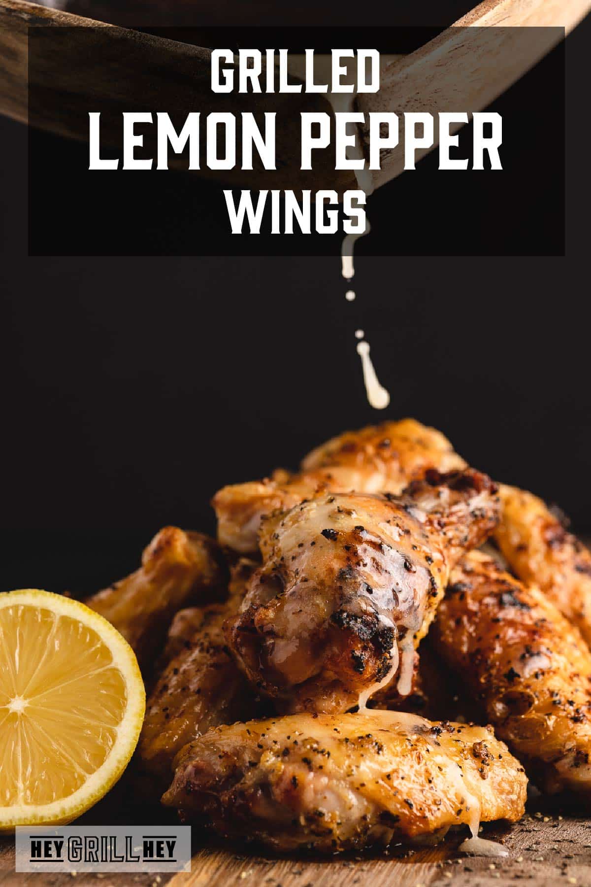 Grilled wings in a pile being drizzled with lemon juice. Text reads "Grilled Lemon Pepper Wings."