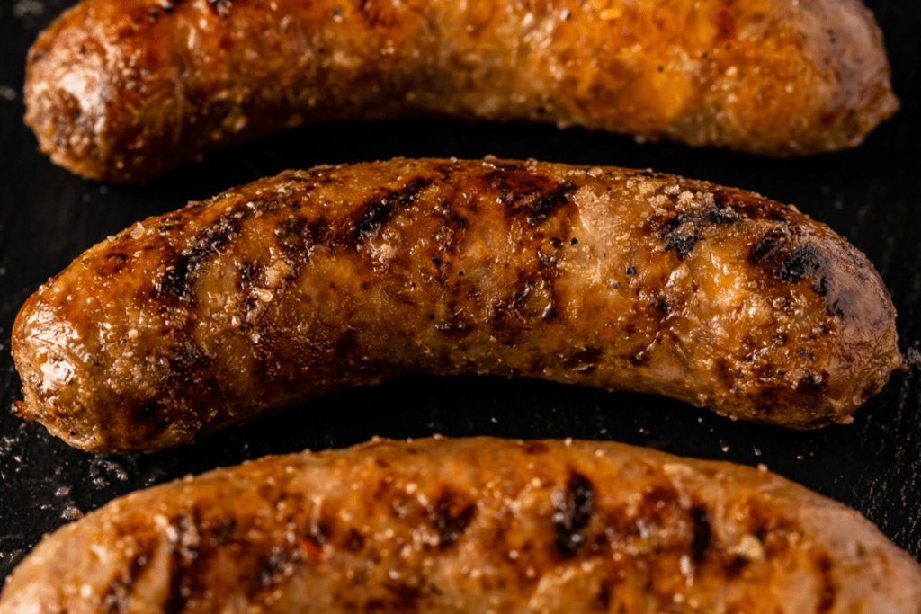 Grilled Italian sausage lined up on a serving platter.