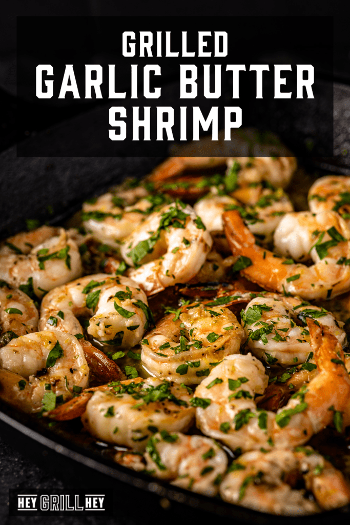 Grilled garlic butter shrimp on a serving dish with text overlay - Grilled Garlic Butter Shrimp.