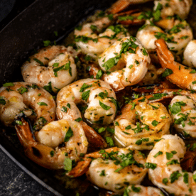 Grilled garlic butter shrimp on a serving dish.