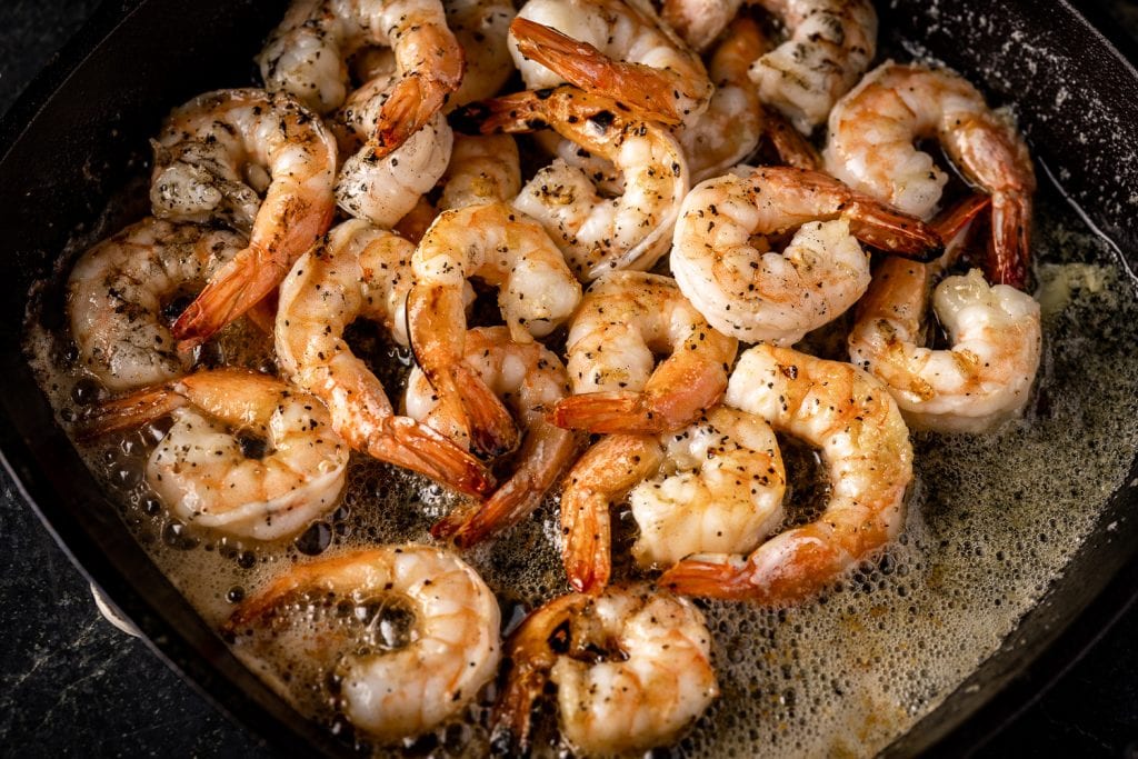 Cooked shrimp in melted butter.