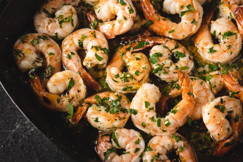 Cooked shrimp in cast iron skillet.