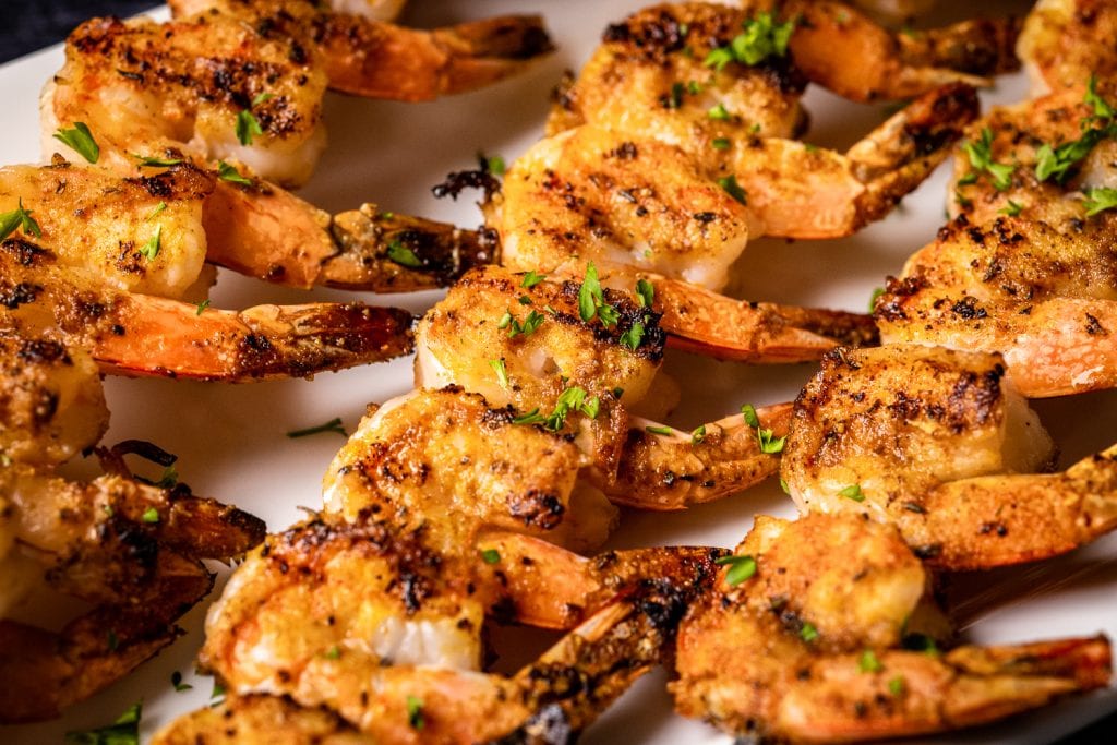Grilled cajun shrimp on a serving platter.