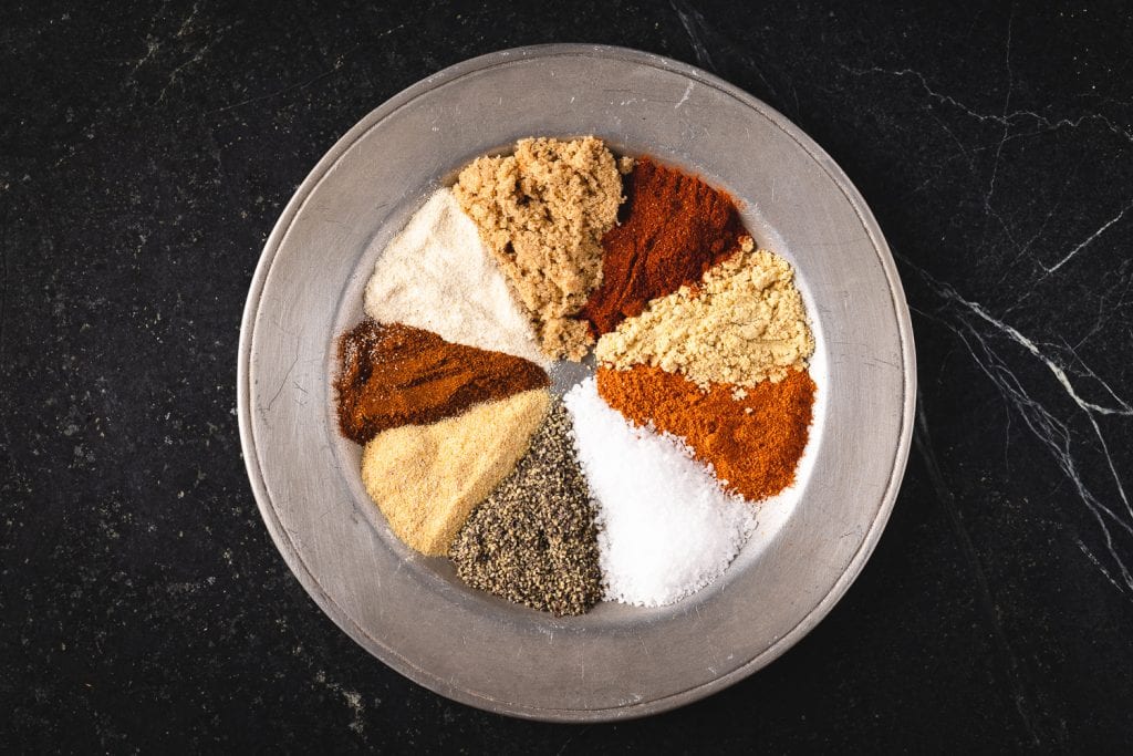 Ingredients for hot sweet rub separated out in a bowl.