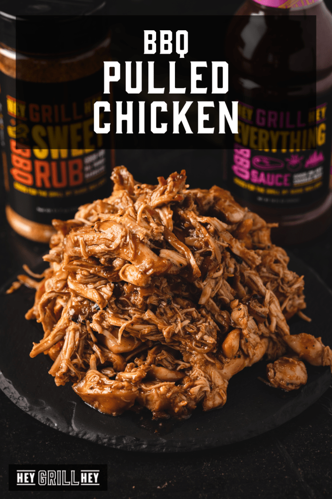 Pile of BBQ pulled chicken on a serving platter with text overlay - BBQ Pulled Chicken.