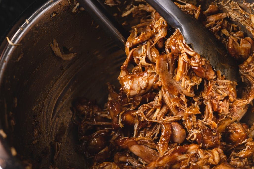 BBQ pulled chicken in a mixing bowl.