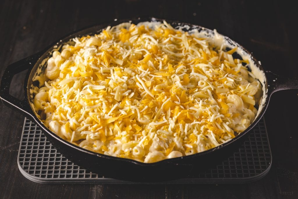 Shredded cheese on the top of mac and cheese.