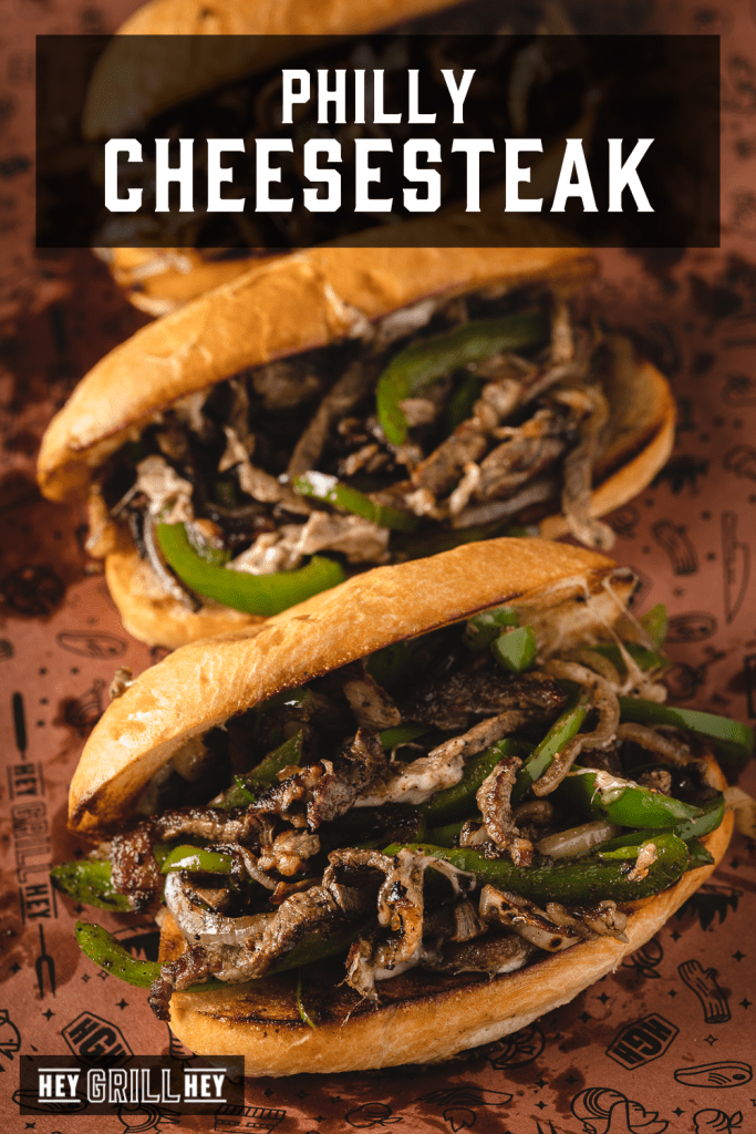 Philly cheese steak on peach butcher paper with text overlay - Philly Cheesesteak.